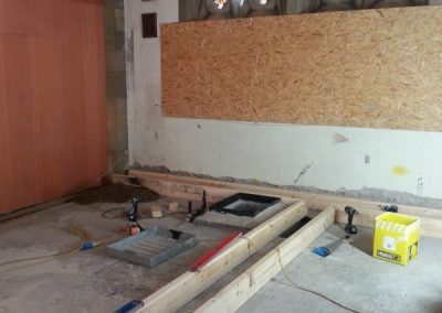Channels for underfloor heating being made in church